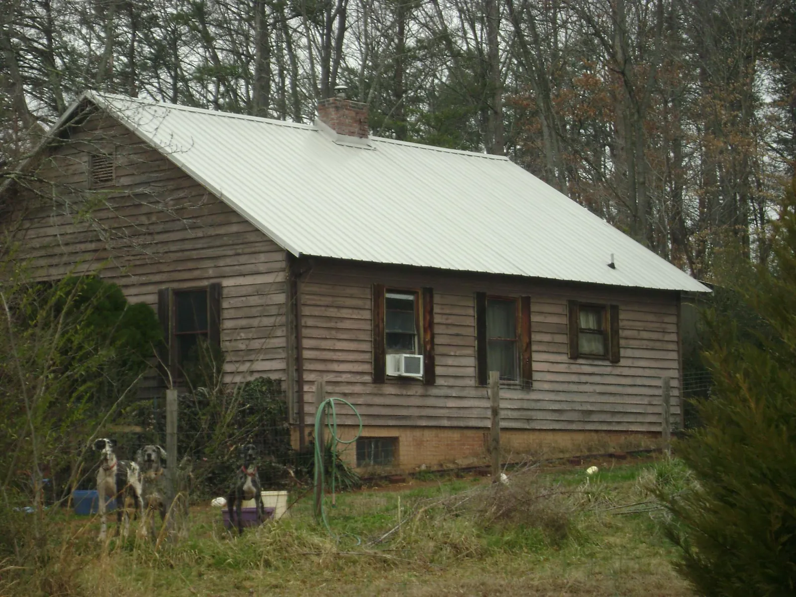 White metal roof on an old wood sided farmhouse, from a Metal Roof Installation job in Broomes Island